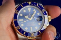 Rolex held between finger and thumb - Submariner Date: Hands-On Review [116613LB]