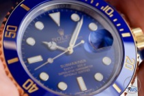Hand held Rolex Submariner Date [116613LB] review with face catching the light